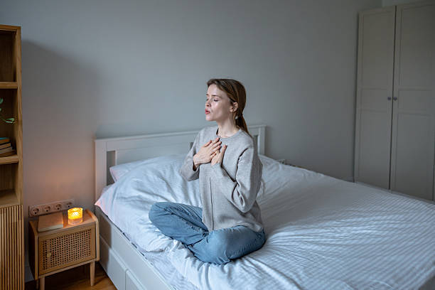 Person seated in calm breathing posture on a cushion